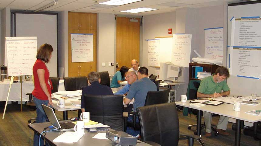 people working together at several tables