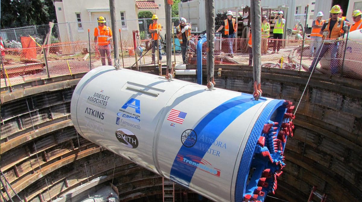 construction team lowering tunnel boring machine