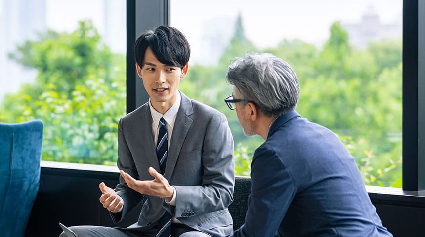 two men in suits talking